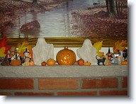 Halloween2008_010 * The living room mantle is decorated with tiny ghosts and pumpkins.  Barb made the little ghosts.  Pipe cleaners form the bodies and little styrofoam balls are the heads.  They're covered with a gauze fabric stiffened with starch. * The living room mantle is decorated with tiny ghosts and pumpkins.  Barb made the little ghosts.  Pipe cleaners form the bodies and little styrofoam balls are the heads.  They're covered with a gauze fabric stiffened with starch. * 1280 x 960 * (593KB)