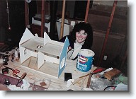 001 * I built my first dollhouse in early 1992.  Here I am working on it in the basement of our home.  It was the Tiffani kit from Greenleaf - a small Victorian style cottage, labeled as an excellent starter house.  I wanted a small house to hold some old dollhouse furniture which I received from my Mom.  The furniture was given to her when she was a young girl (around 1940).  It had belonged to the daughter of a family friend, who was by then grown up.  So... the furniture was probably from the early 1920's at least.  I had such fun building and decorating this little house and I couldn't wait to do another. Thus, what started as a simple project turned into a lifelong hobby. * I built my first dollhouse in early 1992.  Here I am working on it in the basement of our home.  It was the Tiffani kit from Greenleaf - a small Victorian style cottage, labeled as an excellent starter house.  I wanted a small house to hold some old dollhouse furniture which I received from my Mom.  The furniture was given to her when she was a young girl (around 1940).  It had belonged to the daughter of a family friend, who was by then grown up.  So... the furniture was probably from the early 1920's at least.  I had such fun building and decorating this little house and I couldn't wait to do another. Thus, what started as a simple project turned into a lifelong hobby. * 968 x 694 * (258KB)